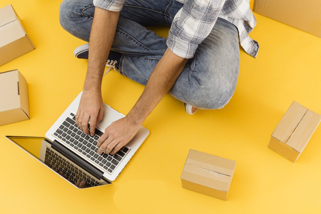 delivery man with laptop packages